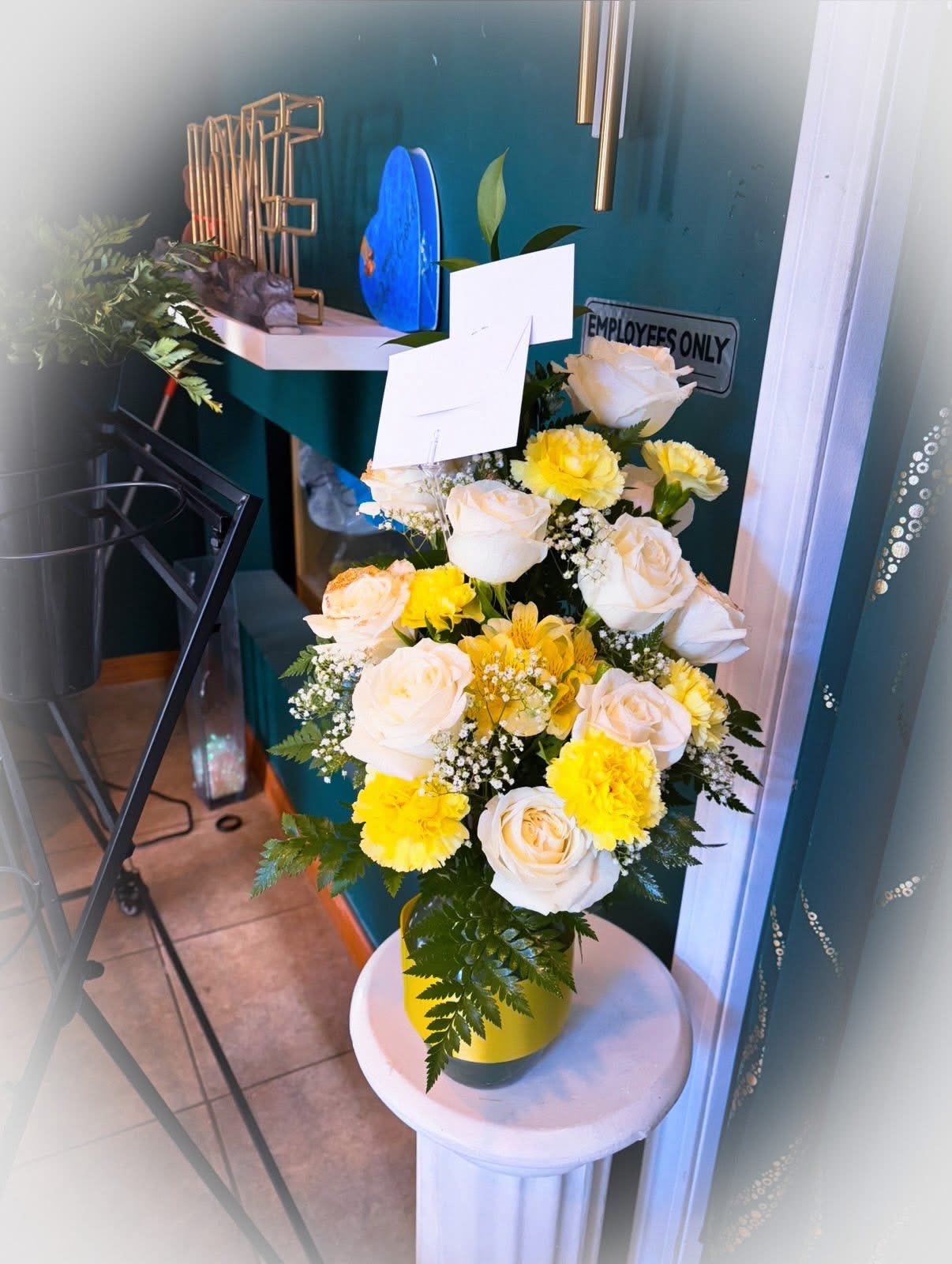 Golden Comfort Bouquet - A cheerful and soft arrangement of white roses paired with bright yellow carnations and accent flowers (like baby’s breath). Arranged in a yellow vase, it gives a warm, uplifting feel—perfect for sympathy, get-well wishes, or celebrating life.  