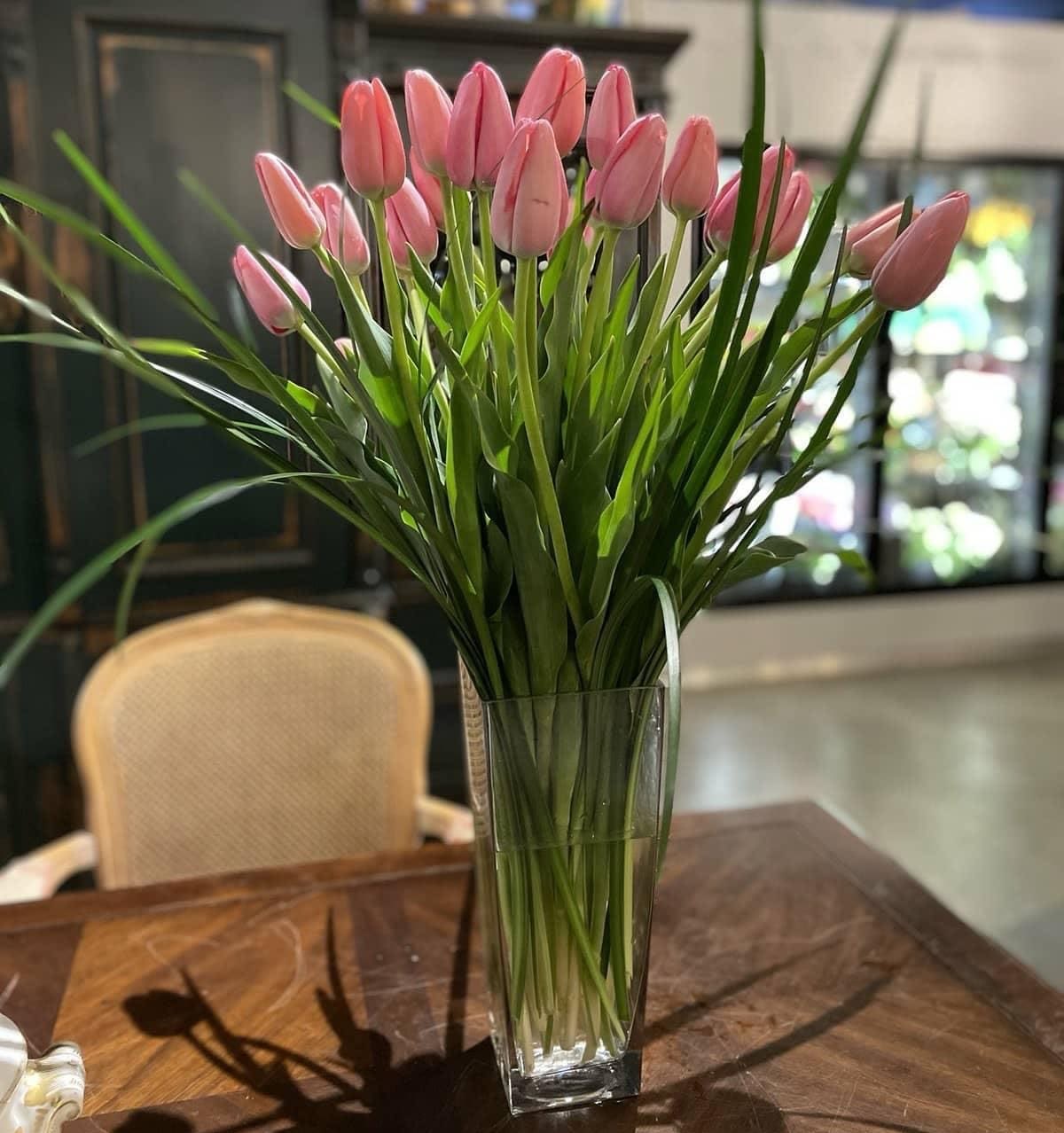 Tulip Lover - Graceful and sophisticated, this arrangement showcases 20 tall, peach tulips in a clear glass vase—an effortless expression of natural beauty. Perfect for those who appreciate simplicity, elegance, and the timeless charm of tulips.  Please note: Flower varieties and container style may vary based on seasonal availability, while always maintaining the overall aesthetic and value.  Freshness Guarantee: At Belden's Florist, we stand behind the quality of every arrangement. Our flowers are guaranteed to remain fresh and beautiful for 3–5 days after delivery. To extend their life, we recommend adding clean water daily. Just like us, flowers thrive with hydration—keeping them nourished helps them bloom beautifully for as long as possible.