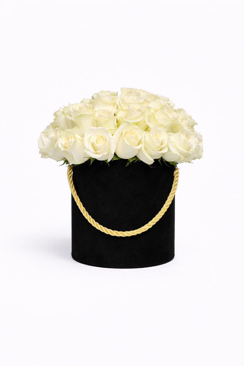 Round box of white roses in a black hatbox with a gold rope handle