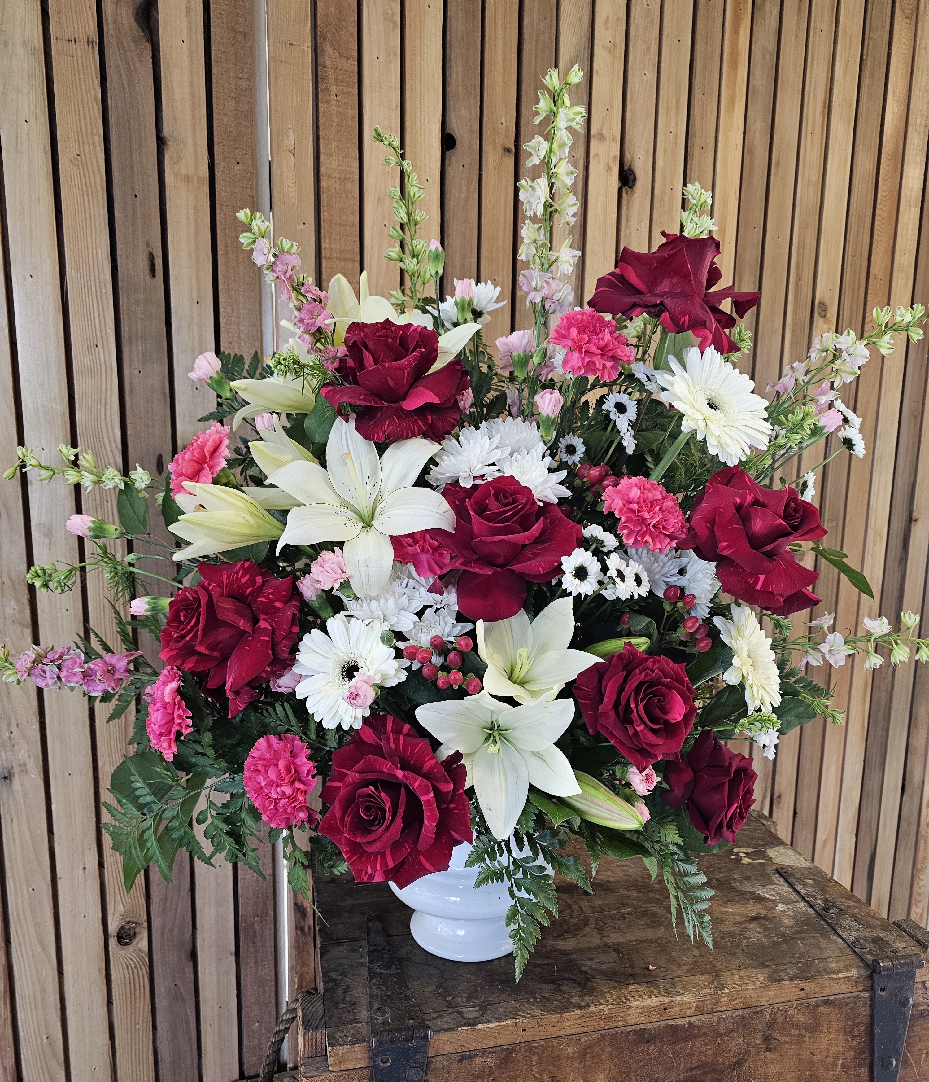 Crimson and Pink Basket - Medium sized arrangement with bold reds and pink.  Set inside a garden of white flowers