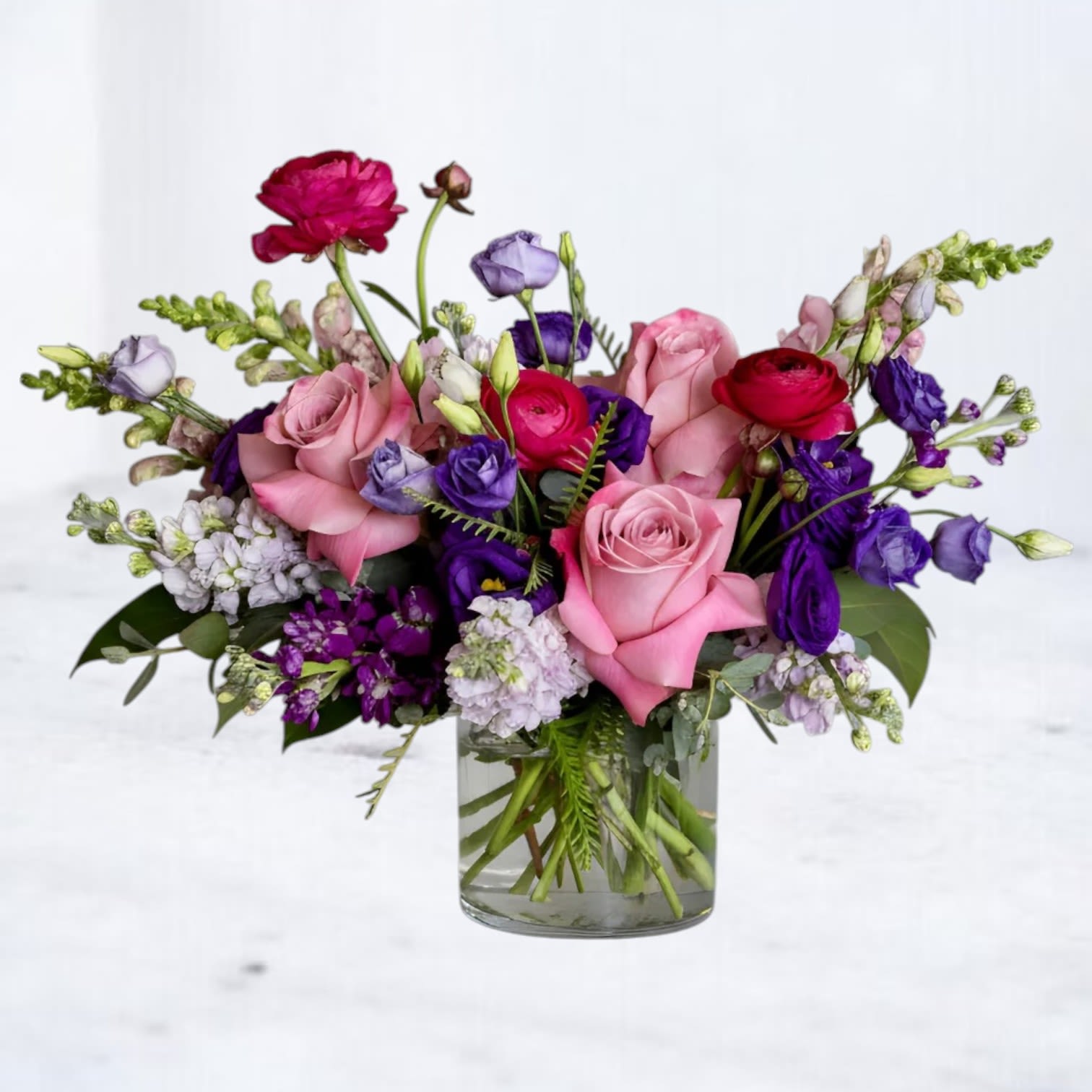 Paradox - Discover the striking beauty of Paradox, a thoughtfully designed flower arrangement that blends soft romance with bold, expressive color. Featuring lush pink roses, vibrant ranunculus, delicate lisianthus, and textured seasonal accents in shades of magenta, lavender, and deep violet, this design creates a dynamic, modern look that feels both elevated and effortlessly natural.  Designed in a clear glass vase, this arrangement highlights the natural movement of each stem, allowing the flowers to open beautifully while maintaining a clean, contemporary presentation. The combination of soft blush tones with richer jewel hues makes Paradox a versatile choice—perfect for birthdays, anniversaries, celebrations, or simply sending something unexpected and meaningful.  At Whiskey Wallflower, every arrangement is created with intention and attention to detail. Paradox is ideal for anyone looking for a luxury flower arrangement in Magnolia, that feels unique and design-forward rather than traditional. Whether you're sending flowers to a loved one, celebrating a milestone, or elevating your space, this arrangement delivers both impact and elegance.  We proudly offer same-day flower delivery in Magnolia, and surrounding areas, including The Woodlands, Montgomery, Conroe, Spring, and Tomball. Each order is carefully prepared to ensure freshness, quality, and a seamless delivery experience.