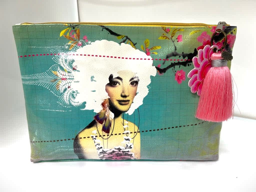 Decorative zip pouch with a woman illustration and pink tassel charm