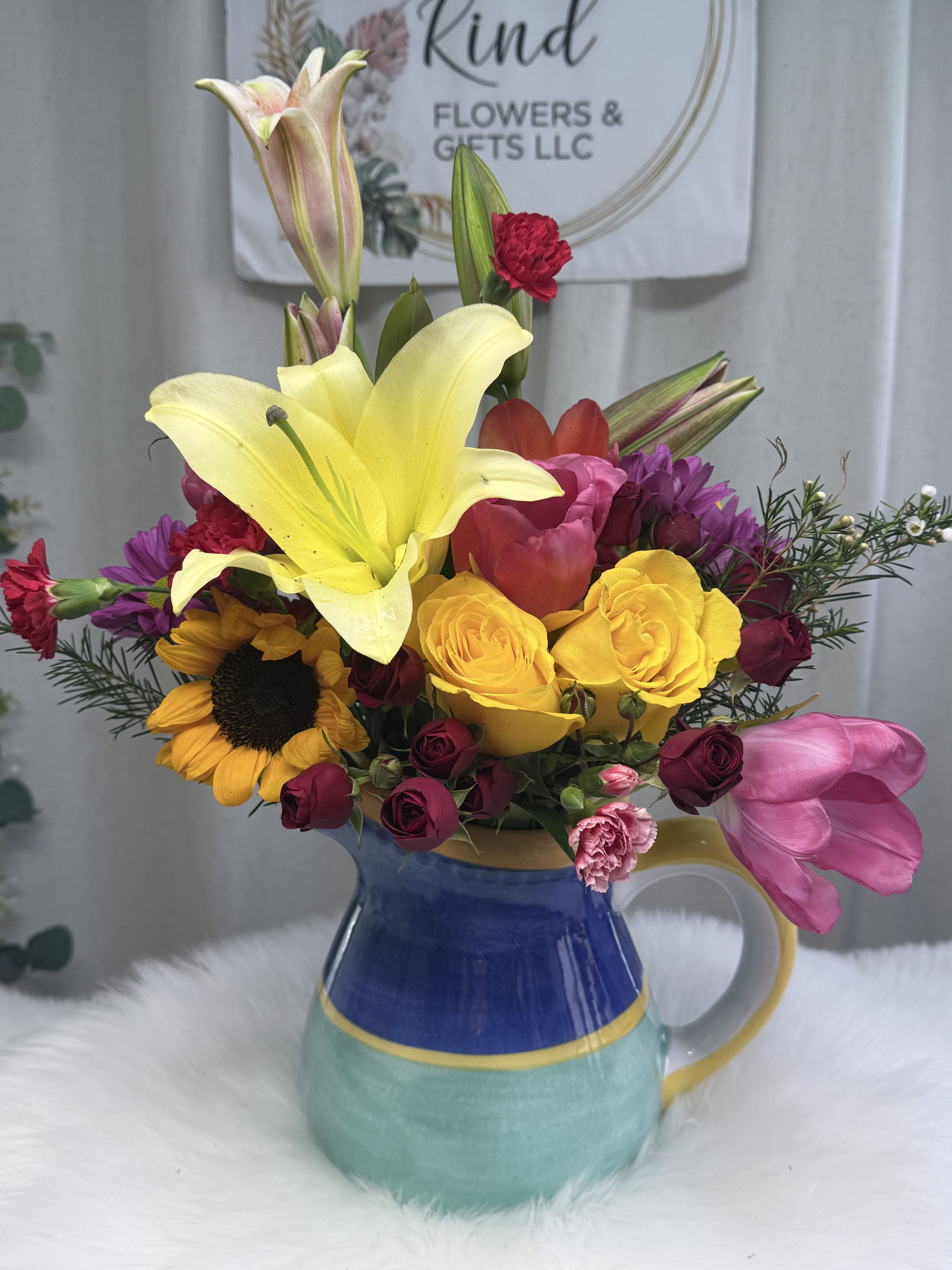 Sunshine Garden Delight - A vibrant and cheerful arrangement designed to brighten any space. This stunning bouquet features a seasonal mix of fresh, colorful blooms such.  Carefully arranged in a charming ceramic pitcher, this one-of-a-kind design brings warmth, elegance, and a touch of joy to any occasion—perfect for birthdays, celebrations, or simply making someone smile.  Flower varieties may vary slightly based on seasonal availability, but the overall look will remain bright, full, and beautiful.