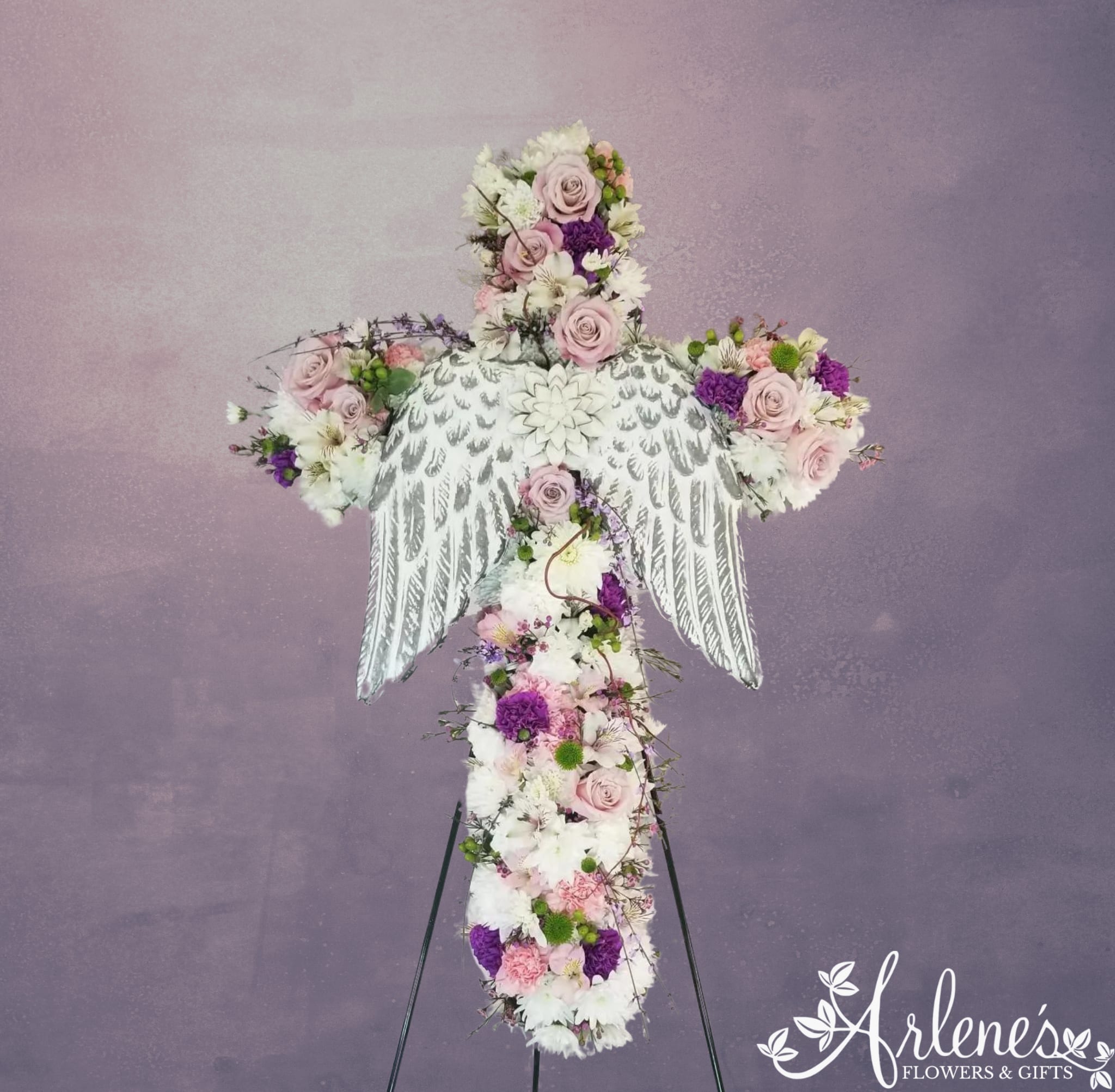 Angelic Cross - This beautiful standing cross spray has metal keepsake wings (styles will vary, please call if you want to know what is currently available)  that can be removed after the service and hung on a wall in remembrance of your angel.