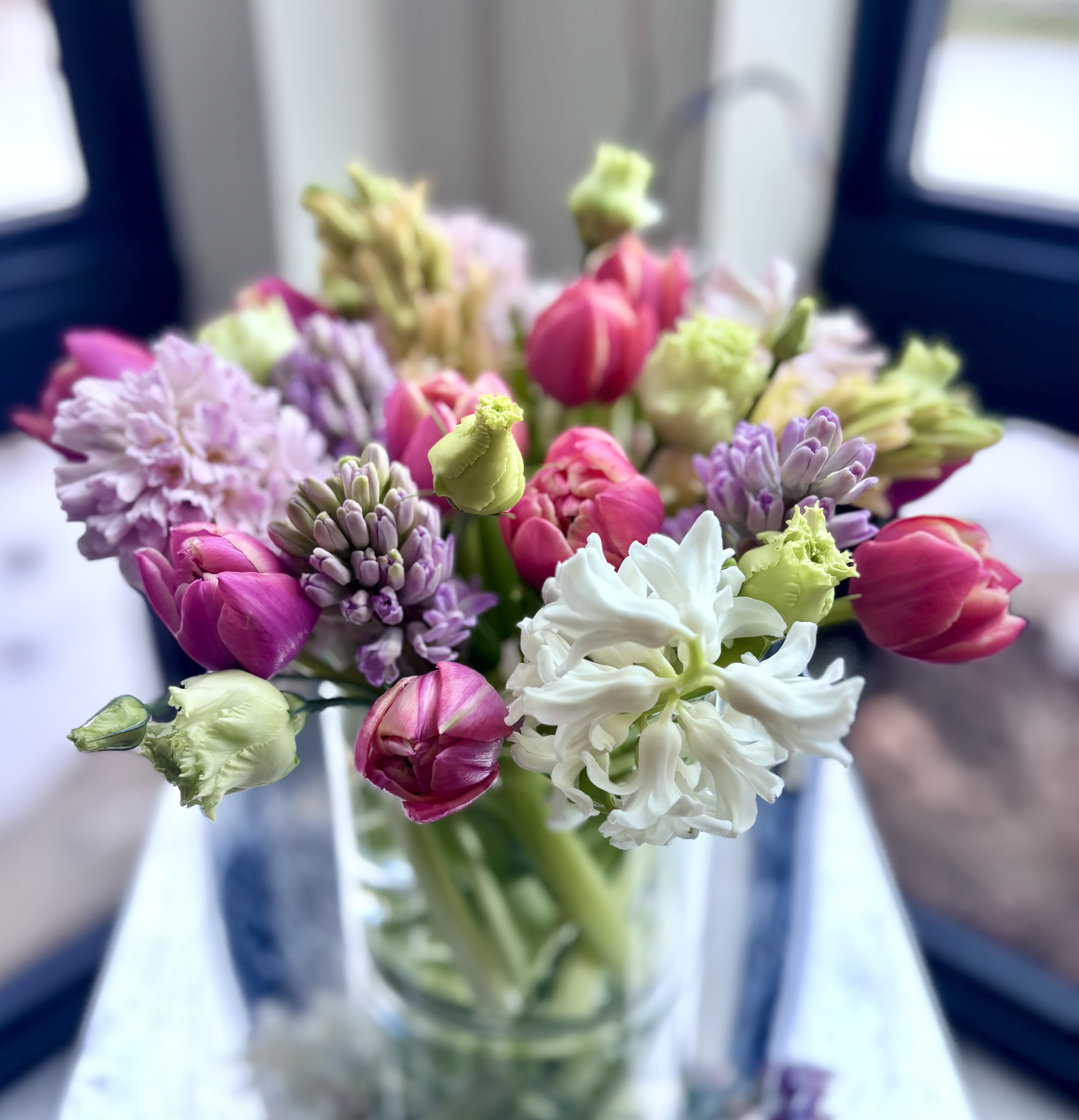 Hyacinths with Tulips - A simple elegant flower arrangement of fragrant hyacinths and tulips, with greenery mixed in. The color may vary or request your favorite color combination in advance and we will do our best to accommodate your preference.