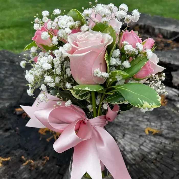 Posey Pinks - Mixed pink roses and spray roses with baby's breath in a petite, hand-tied posey bouquet. 