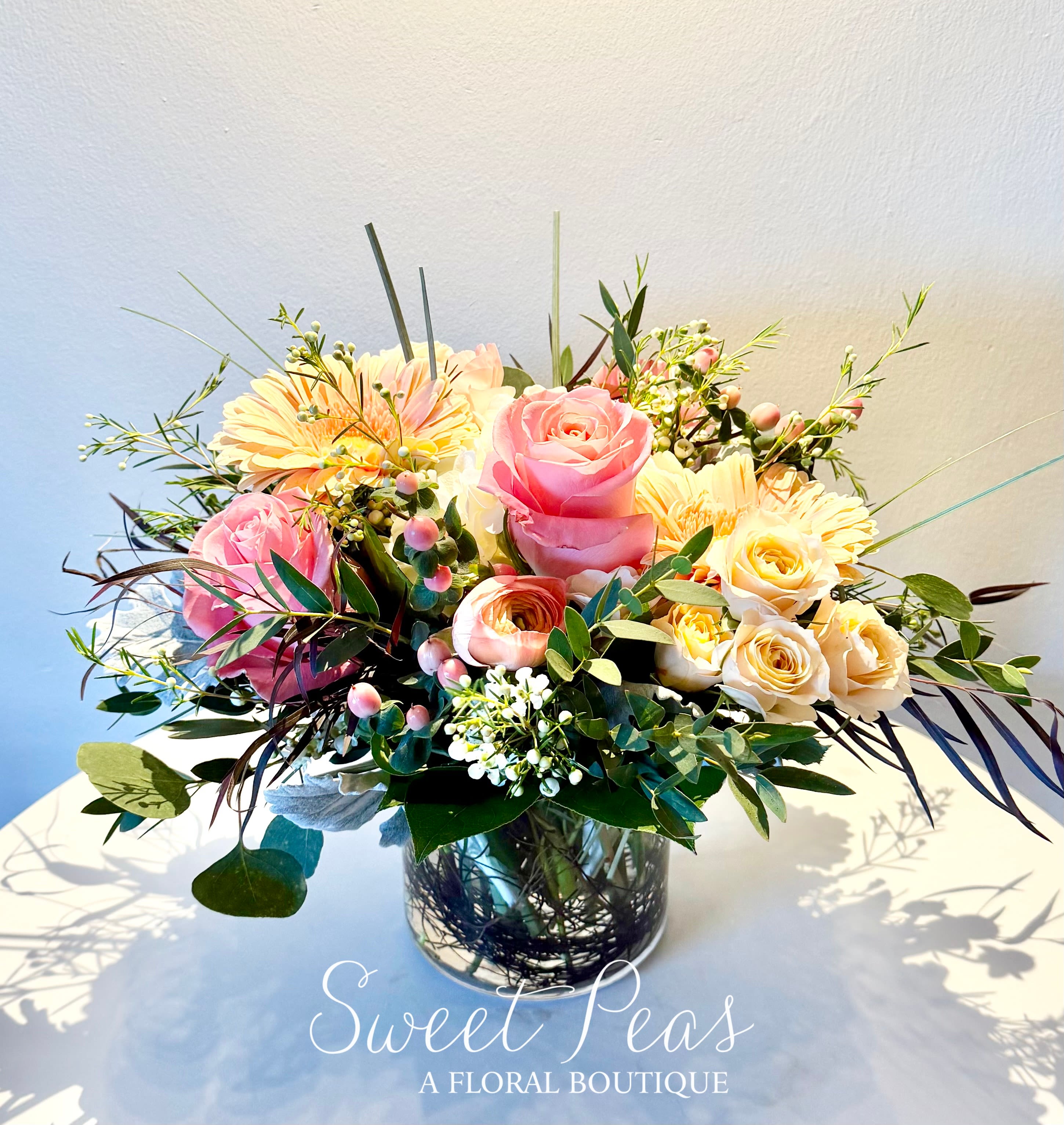 Pink and cream rose bouquet in a glass vase