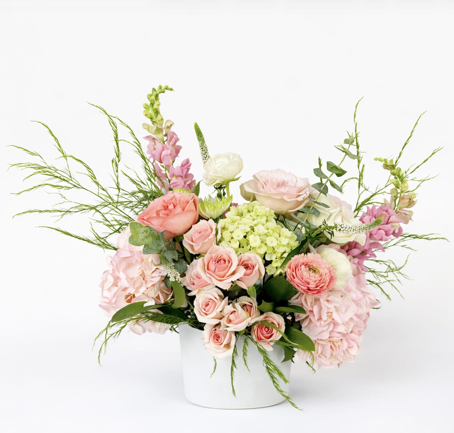 Blush Luxe Garden - A soft, romantic arrangement featuring lush blush and peach tones with delicate garden textures. Designed with premium seasonal blooms in a modern vessel, this piece brings effortless elegance to any space. 