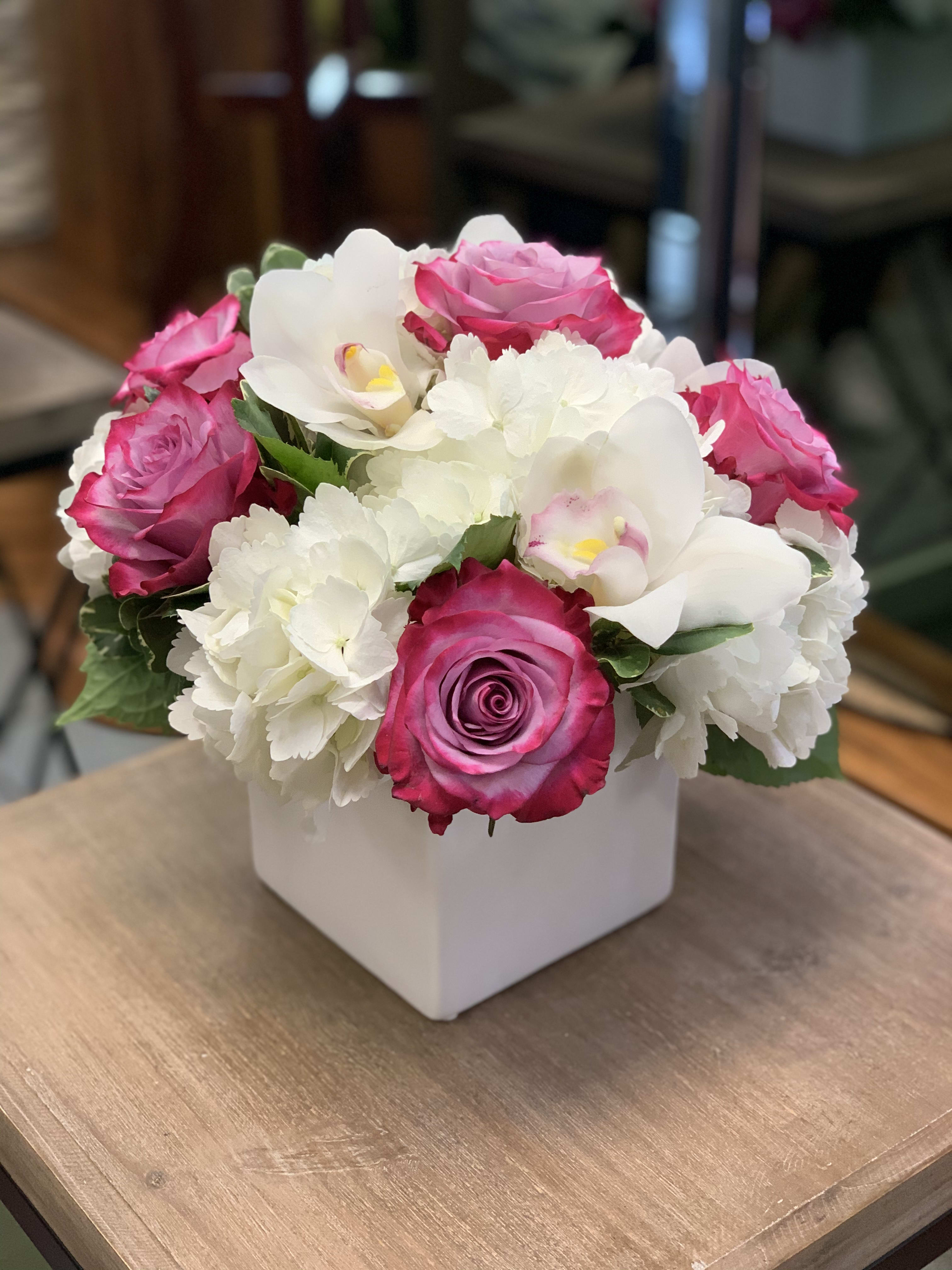 Daydreams - Creamy white orchids, white hydrangeas, and deep purple roses roses are a great way to tell someone that you are thinking of them! 