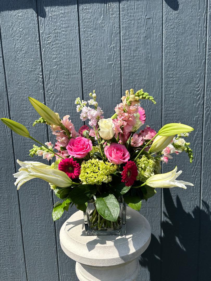 Classic Harmony - A beautiful burst of Lilies, Roses, Snapdragons, Stock, Gerbera and Green Hydrangea in a simple clear vase. A  charming, versatile,  lively and classic look.