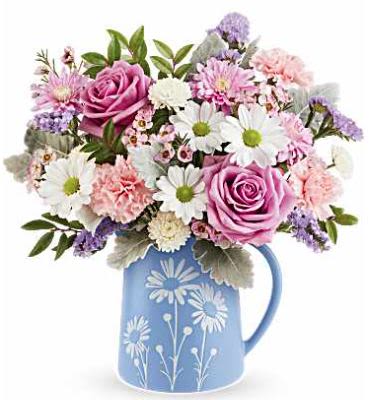 Pastel Meadows - Teleflora's Pastel Meadow Bouquet includes lavender roses, pink carnations, white button spray chrysanthemums, lavender cushion spray chrysanthemums, white daisy spray chrysanthemums, blue sinuata statice, pink waxflower, dusty miller, and huckleberry, arranged in Teleflora's Daisy Dreams Pitcher, a keepsake blue pitcher with a white daisy design. 