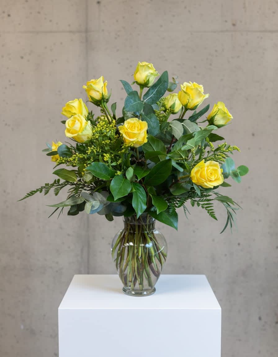 Tall arrangement of yellow roses in a clear glass vase