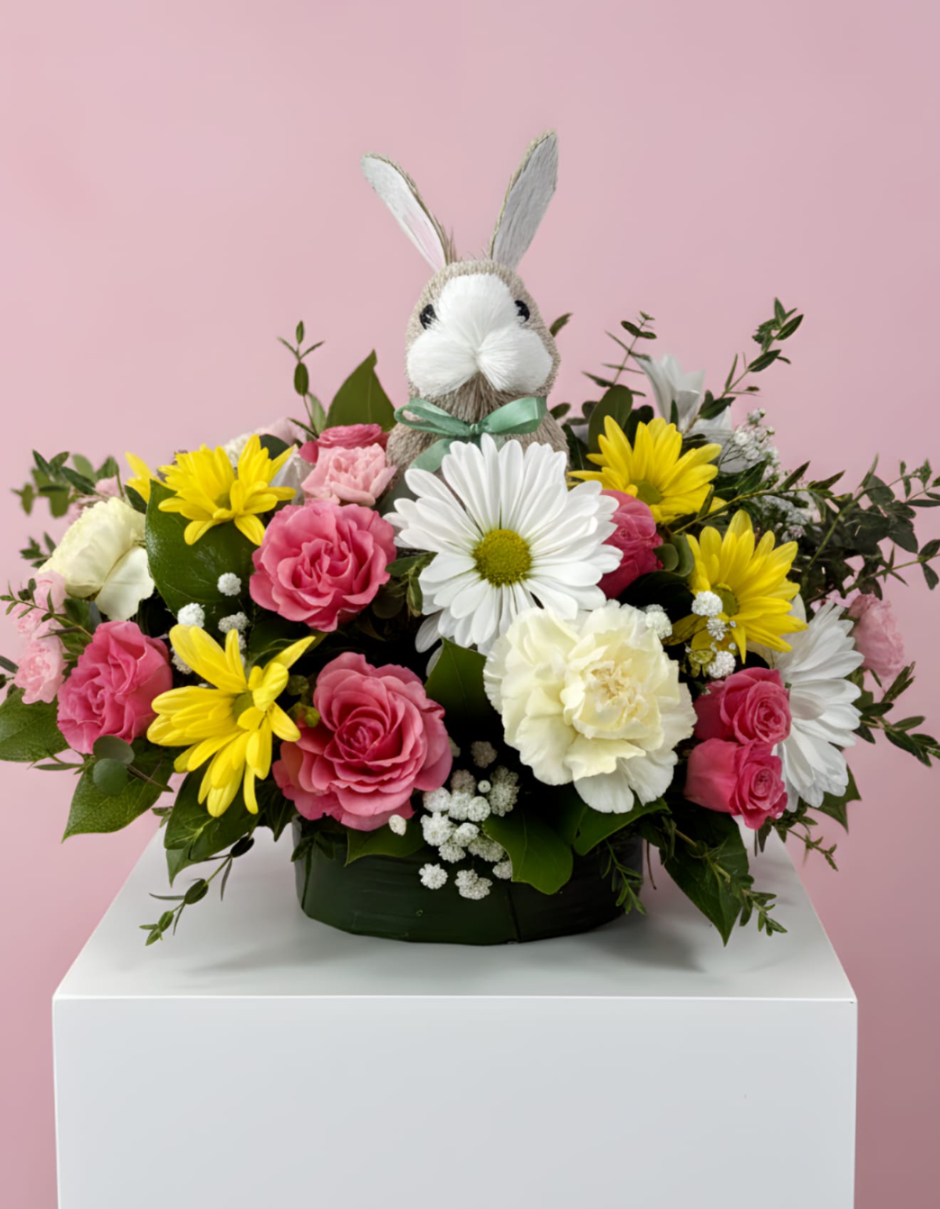Easter Spring Centerpiece With Bunny - A mix of pink roses, yellow daisies, white daisies, and fresh greenery arranged with a keepsake bunny. Perfect for Easter or spring gifting.