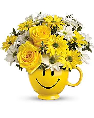 Be Happy Arrangement by teleflora - There are probably a million reasons this is such a popular bouquet. Of course, there are probably just as many reasons to send this cheerful arrangement. Full of happy flowers, this ceramic happy face mug will bring smiles for years to come. Especially when filled with that first cup of morning coffee or cocoa! Yellow roses, spray roses and daisy spray chrysanthemums along with white daisy spray chrysanthemums and oregonia are delivered in the one and only Be Happy® mug.  