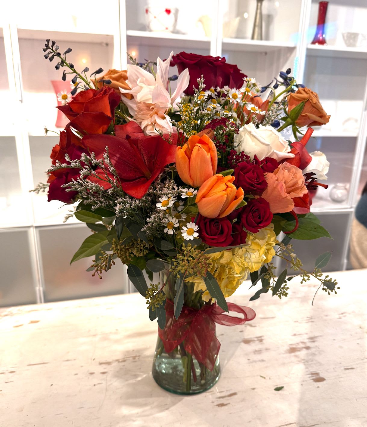 DESIGNER'S CHOICE - WILDFLOWER  - Mixed (SEASONAL) - This country wildflower–inspired arrangement brings the charm of open fields and simple country living into bloom.   A relaxed mix of meadow-style flowers, soft textures, and fresh greenery is loosely arranged for a natural, gathered-from-the-garden feel.   Warm, cheerful, and unpretentious, this design feels right at home in any space—perfect for sending comfort, sharing a smile, or adding a touch of rustic beauty to the day.  *SEASONAL - FLOWERS MAY VARY DUE TO AVAILABILITY. 