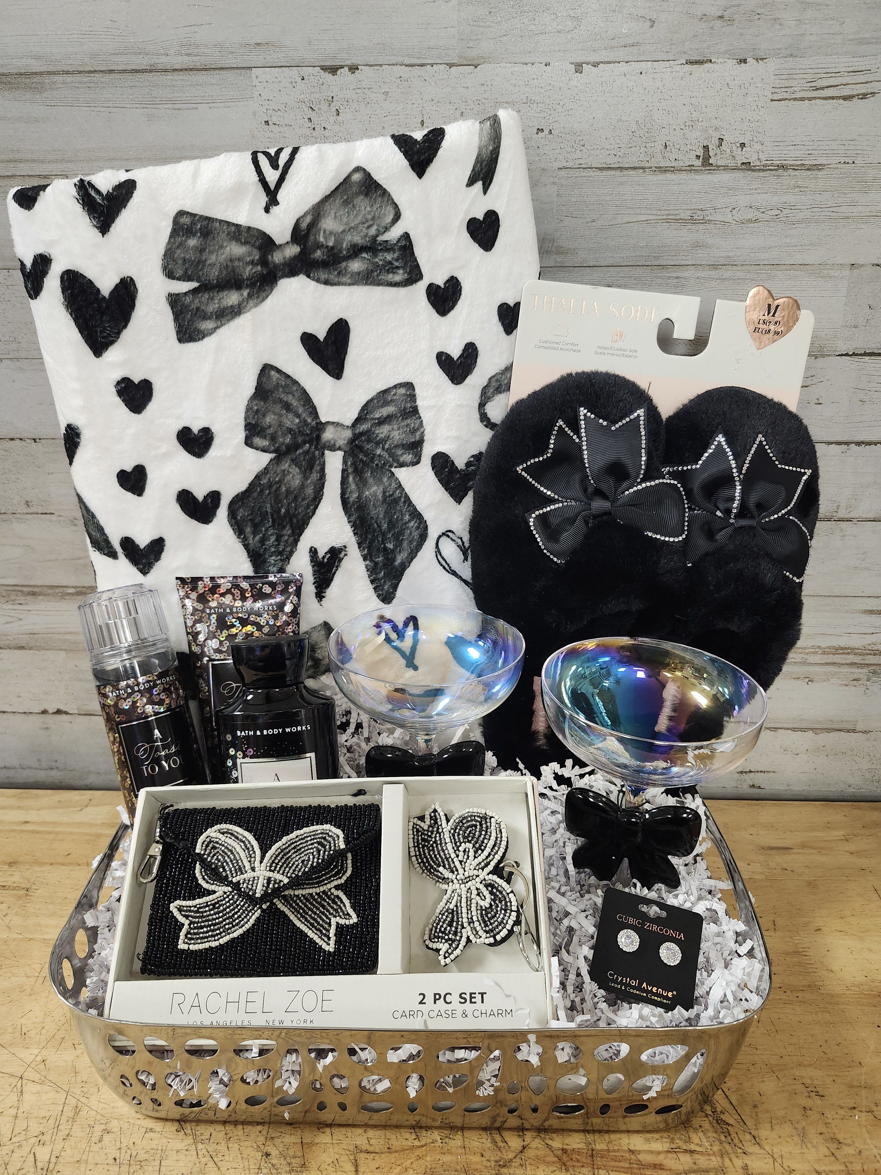 Bow to You - $225 - Show your love &amp; affection as you deliver bows to your person!  Basket Contains: - Faux Fur Slippers - With Rhinestone Accents - Set of 2 -  Iridescent Martini Glasses with Bows on Stem - Beaded Wallet &amp; Key Chain gift set - Plush Blanket with Matching Black Bows - A Toast to You      - Body Wash      - Lotion      - Fragrance Mist - Silver Rhinestone Earrings - Delivered in Silver Serving Tray