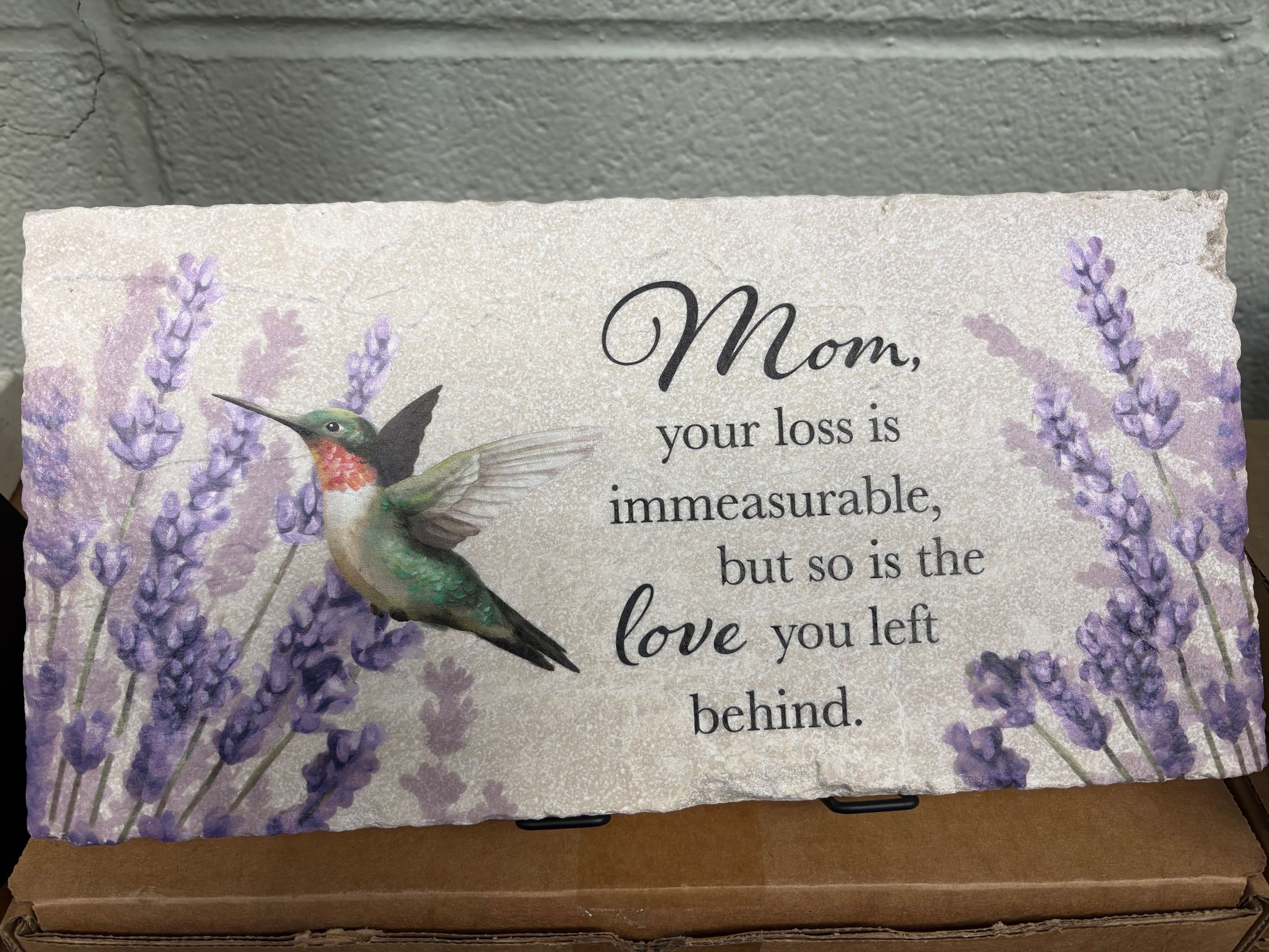 "Mom" Marble Paver with Easel - This marble paver comes with a beautiful print of a hummingbird among flowers with the following commemorating phrase: "Mom, your loss is immeasurable, but so is the love you left behind."