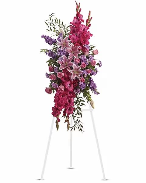 Touching Tribute Spray - Express admiration for her beauty and spirit with a striking tribute certain to evoke many cherished remembrances. Gorgeous flowers such as pink roses, oriental lilies and gladioli blend with purple stock, lavender carnations and fragrant greens.
