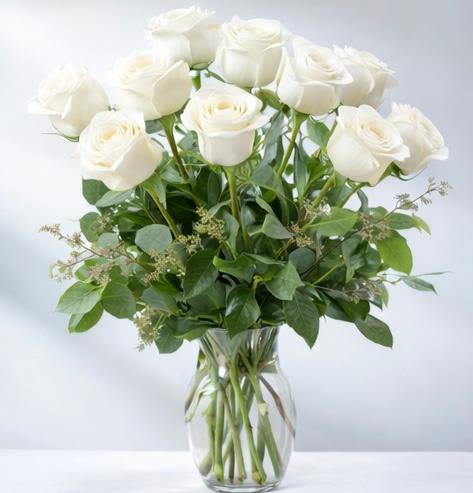 White Rose Bouquet - Nothing speaks of love so much as a bouquet of beautiful roses. Arranged in a classic glass vase, this bouquet is a gift to her heart from yours. Standard rose bouquet includes 12 stems, approximately 18"H x 12"W,  Deluxe rose bouquet includes 18 stems, approximately 19"H x 16"W, Premium rose bouquet includes 24 stems, approximately 20"H x 18"W.