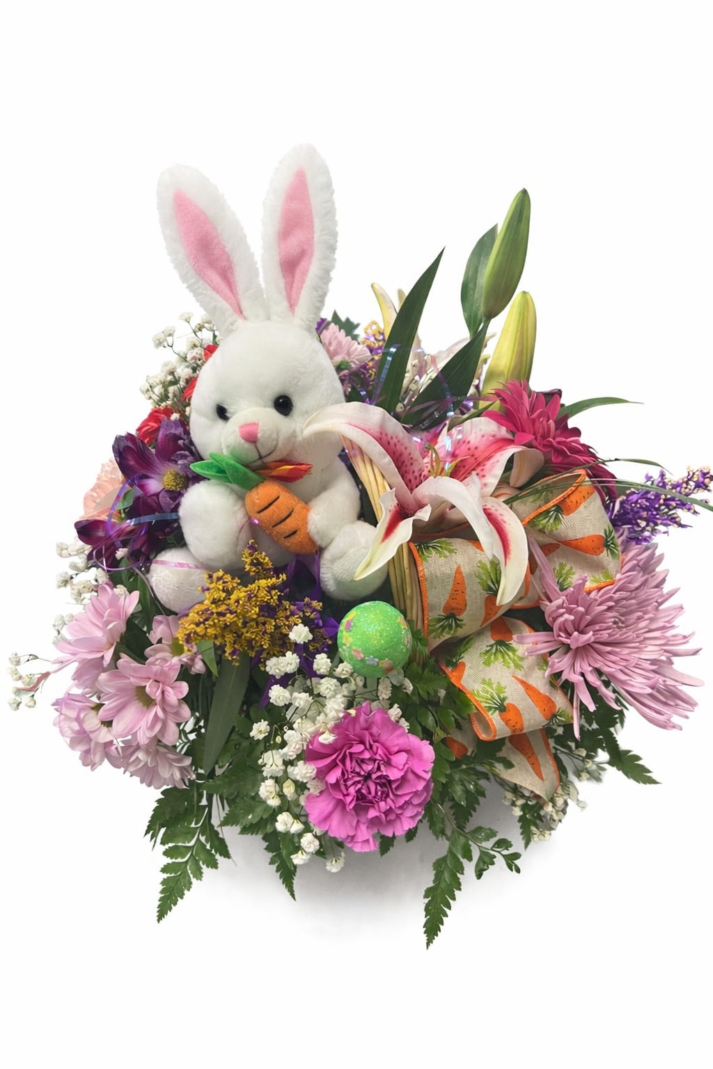 Peter Carrot - Mixed spring flowers with Easter decorations, in a wicker basket.