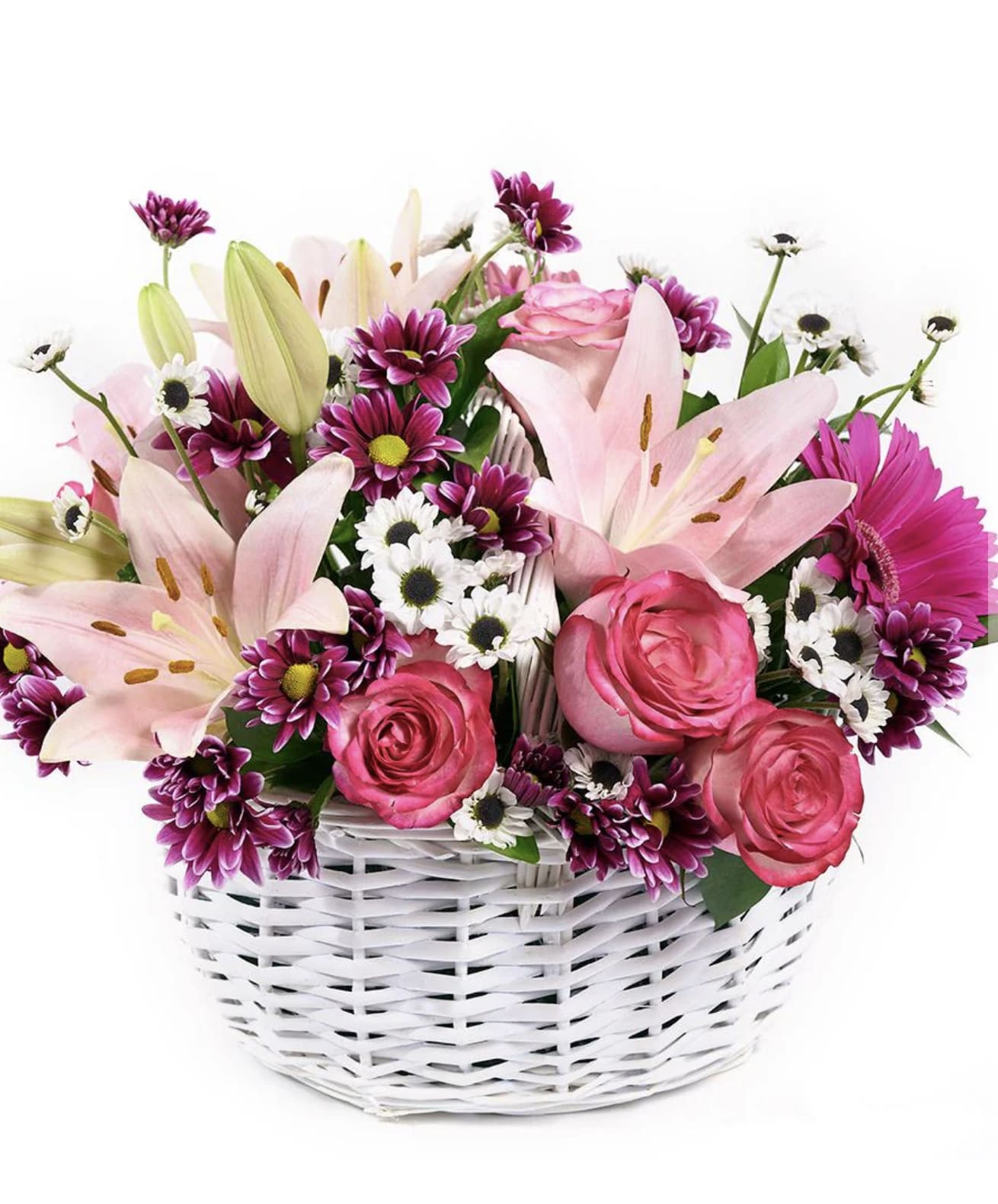 Basket of pink lilies, roses, and mixed daisies arranged in a white woven container
