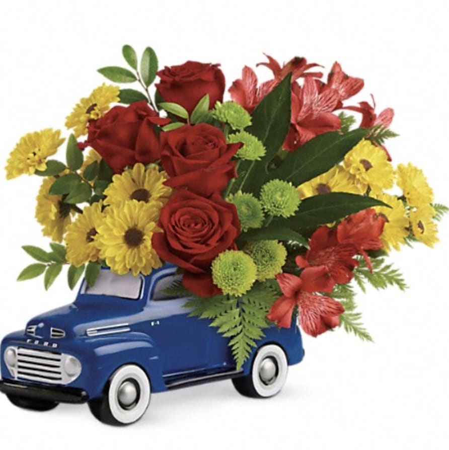 Glory Days Ford Pickup  - Description  Celebrate Dad with fresh flowers in his favorite Ford! Bursting with classic Americana flair, this jaunty little pickup is a super fun way to present Dad with a bright Father's Day bouquet of roses, alstroemeria and mums.  Red roses, red alstroemeria, green button spray chrysanthemums, and yellow daisy spray chrysanthemums are arranged with aralia leaf, huckleberry, and leatherleaf fern.