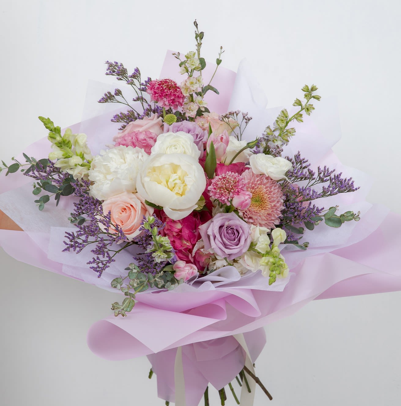 For Someone Special - A soft, romantic garden bouquet made with premium seasonal blooms. This is a full, generously sized bouquet with a lush, airy feel — perfect when you want something that truly stands out. Flower types may vary depending on the season.