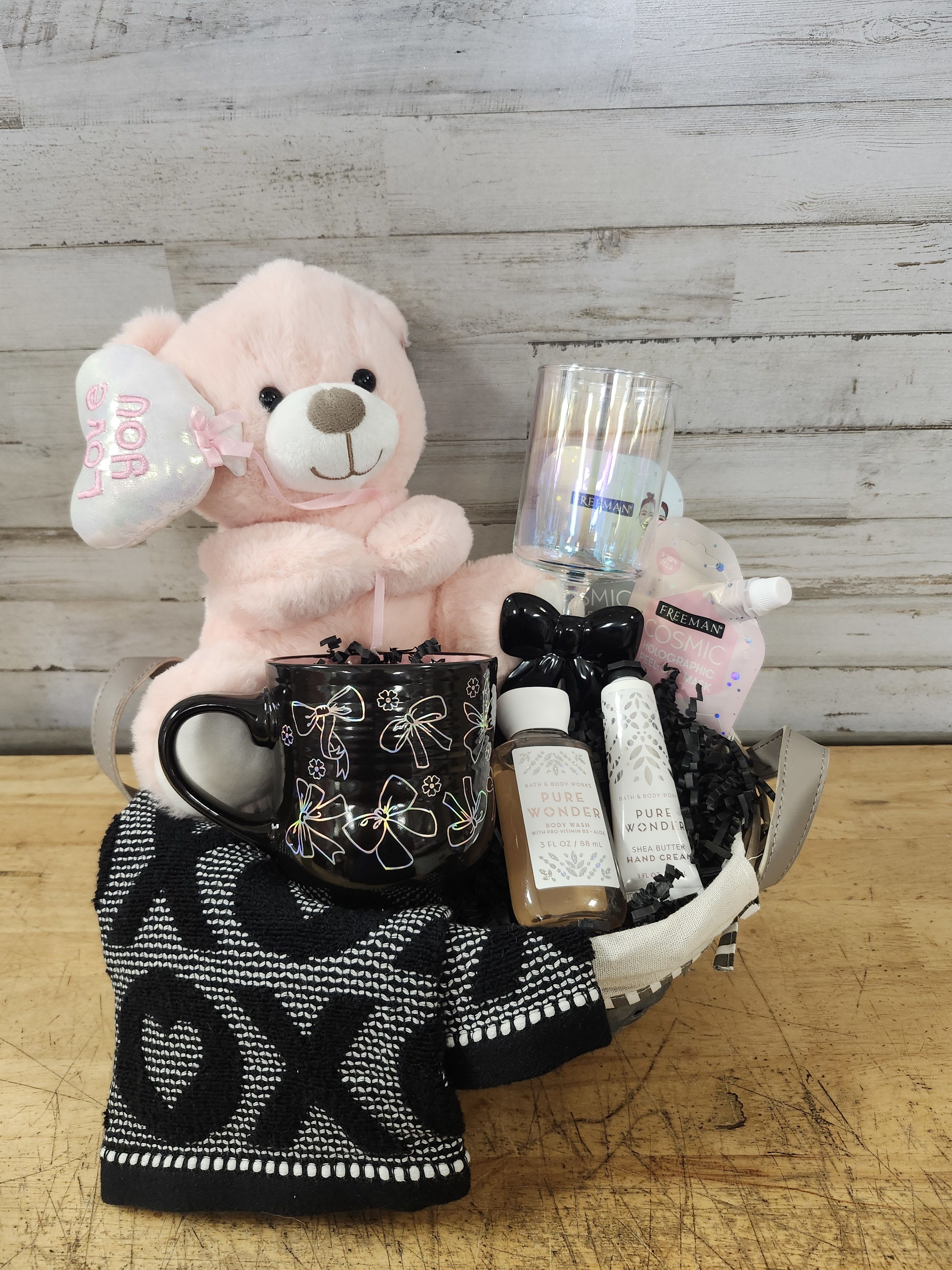 Holographic Bows - $99 - Let your love shimmer &amp; shine with this fun holographic gift basket.   Basket Contains:  - Holographic Ceramic Coffee Mug - Bow Tea Towel - Holographic Champagne Flute with Black Glass Bow on Stem - Teddy Bear with Iridescent Balloon. - Holographic Face Mask - Pure Wonder - Lotion - Pure Wonder - Body Wash - Delivered in Wicker Basket with Handle
