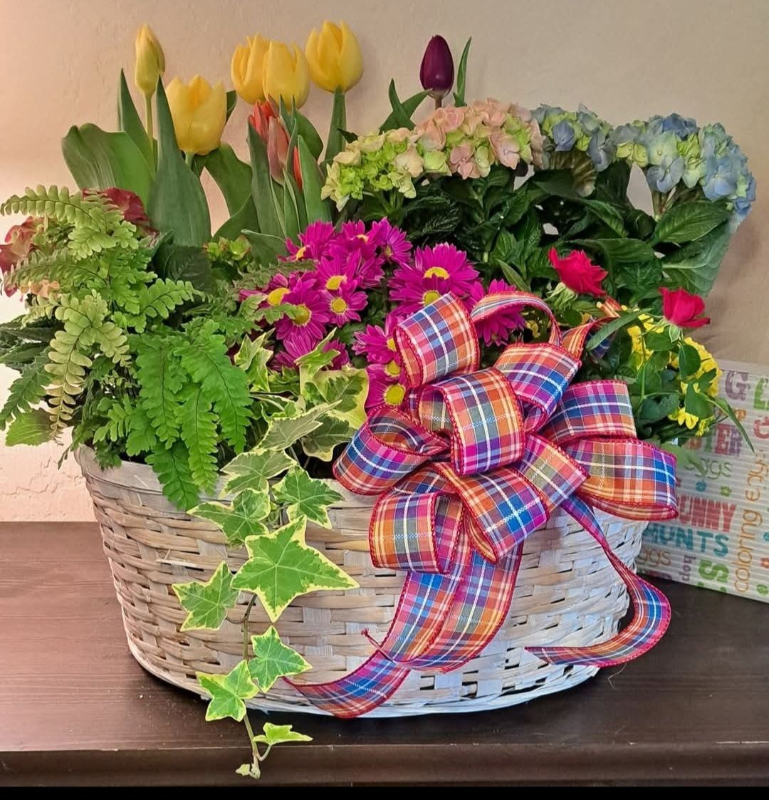 Blooming Garden - We fill an extra large basket (18")with seasonal blooming plants all of which can be re-planted. Hydrangeas, mums, ivy, tulips, hyacinth, kalanchoe, spray roses and a variety of other types of plants may be used. Add on a bow for a gift of any occasions. 