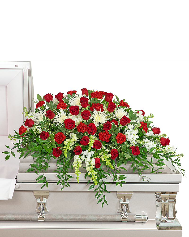 Serene Sanctuary Casket Spray - Our Serene Sanctuary Casket Spray is a classic red and white funeral flower design. It features roses, Carnations, Spider Mums, Hydrangea, Snapdragons, Stock, and other premium foliage. The casket spray is typically provided by the spouse or immediate family as a heartfelt memorial from the family. Funeral flowers bring healing to the family and friends of a lost loved one. A similar look can be achieved with other colors and flowers. For any and all family flowers, feel free to contact our shop for ideas and variations to make your final tribute extra unique and special.