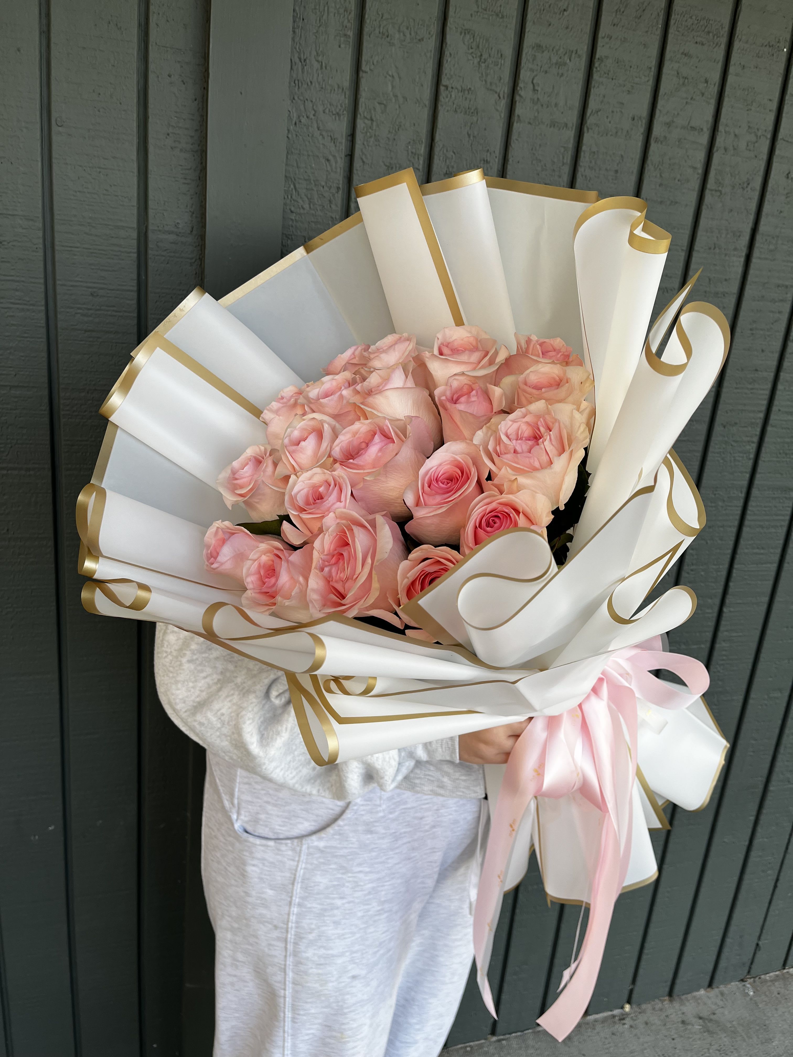 Bouquet of 20 Pink Roses - Absolutely! Here’s a short description: “This stunning bouquet features 20 fresh pink roses, elegantly wrapped to create a timeless and romantic gift. Perfect for expressing love, gratitude, or simply brightening someone’s day.  