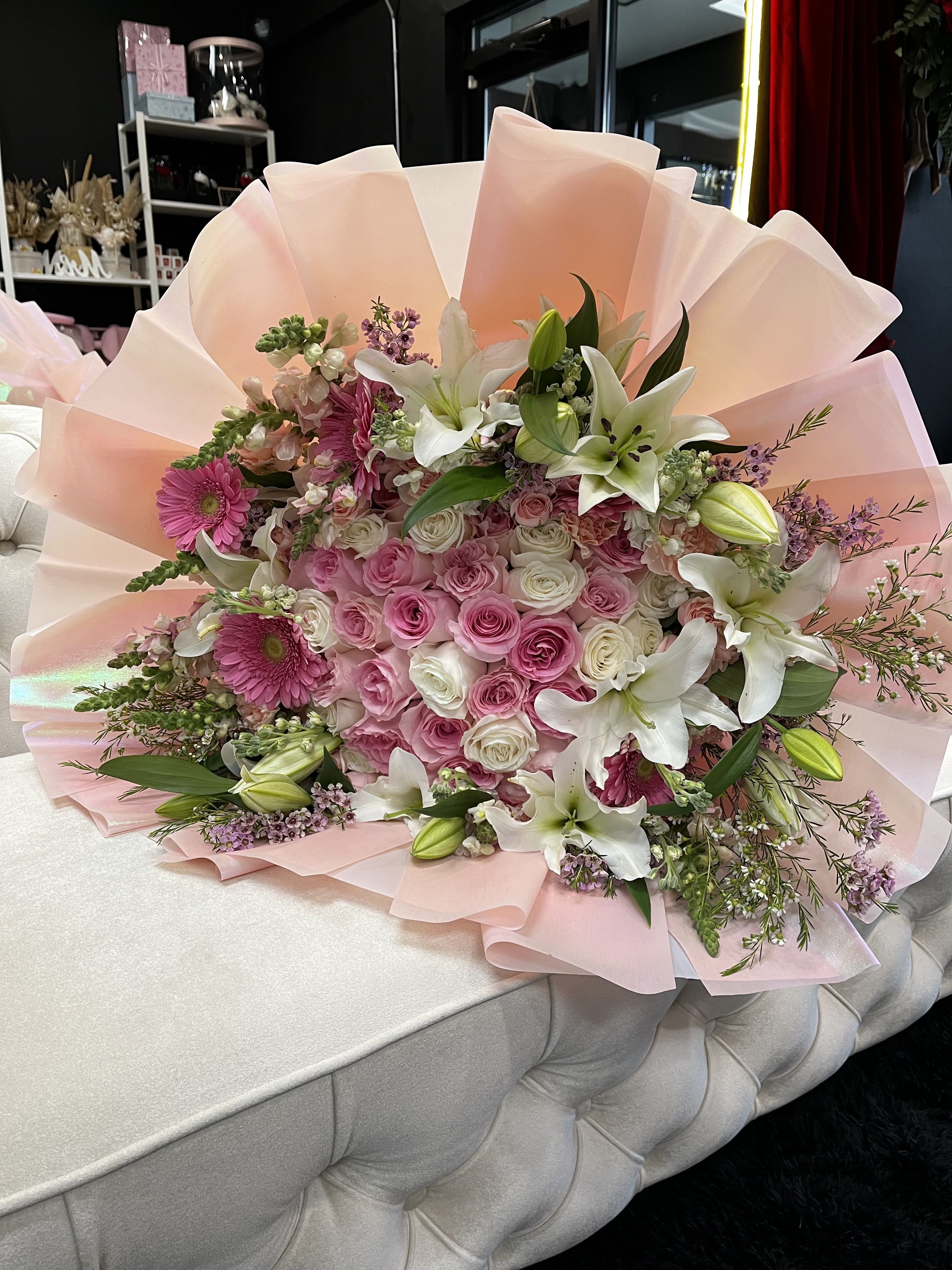 Colorful Border of 35 Roses - This stunning arrangement features 35, 45, 55 elegant roses at its center, surrounded by a vibrant border of multi-colored blooms. A perfect blend of classic beauty and joyful color, ideal for any celebration or heartfelt gesture.”