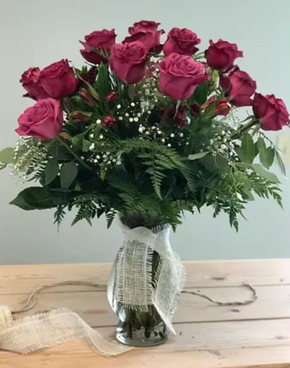 Long Stemmed “Blueberry” Roses - Designed in a clear glass vase with subtle textural detail, this piece blends classic romance with a fresh, modern feel.  Our blueberry roses have a deep purple / mauve pink tone. 