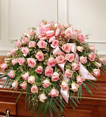50 Rose Casket Cover - Pink - Celebrate a life well lived and loved with this beautiful pink casket spray.  Features gorgeous long stem pink roses, waxflower and vibrant greenery Traditionally sent by the immediate family to the funeral home Our florists use only the freshest flowers available, so colors and varieties may vary Arrangement measures approximately 16”H x 28”W x 36”L