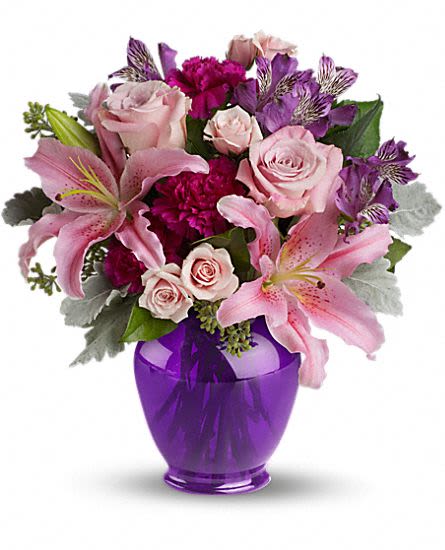 Elegant Beauty - Take their breath away with a spectacular array of pink roses and lilies in a classic ginger jar in deep royal purple. Truly a stunning gift, but without a stunning price tag. The opulent bouquet includes pink roses, light pink spray roses, light pink oriental lilies, purple alstroemeria and fuchsia carnations accented with assorted greenery.  