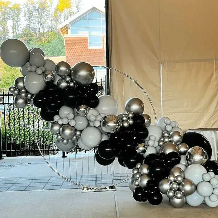 Beyond Bars Backdrop - Silver - Create your own backdrop or focal point at your event. This metal circle arch is a beautiful addition to your event covered in florals, greenery or balloons. Lightweight metal is easily weighted with sand bags (not included). 6ft Tall 6ft Wide Ordering online is not available. Call or email to inquire availability and additional fees.