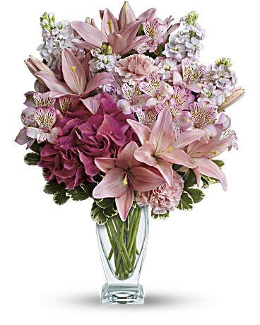 Blush of Love Bouquet - Make her blush with this romantic mix of fragrant lilies and lush hydrangea in dreamy shades of pink. Presented in our elegant couture glass vase, this beautiful bouquet is affection perfection! Includes pink hydrangea, asiatic lilies, alstroemeria, carnations and stock, accented with fresh greens. 