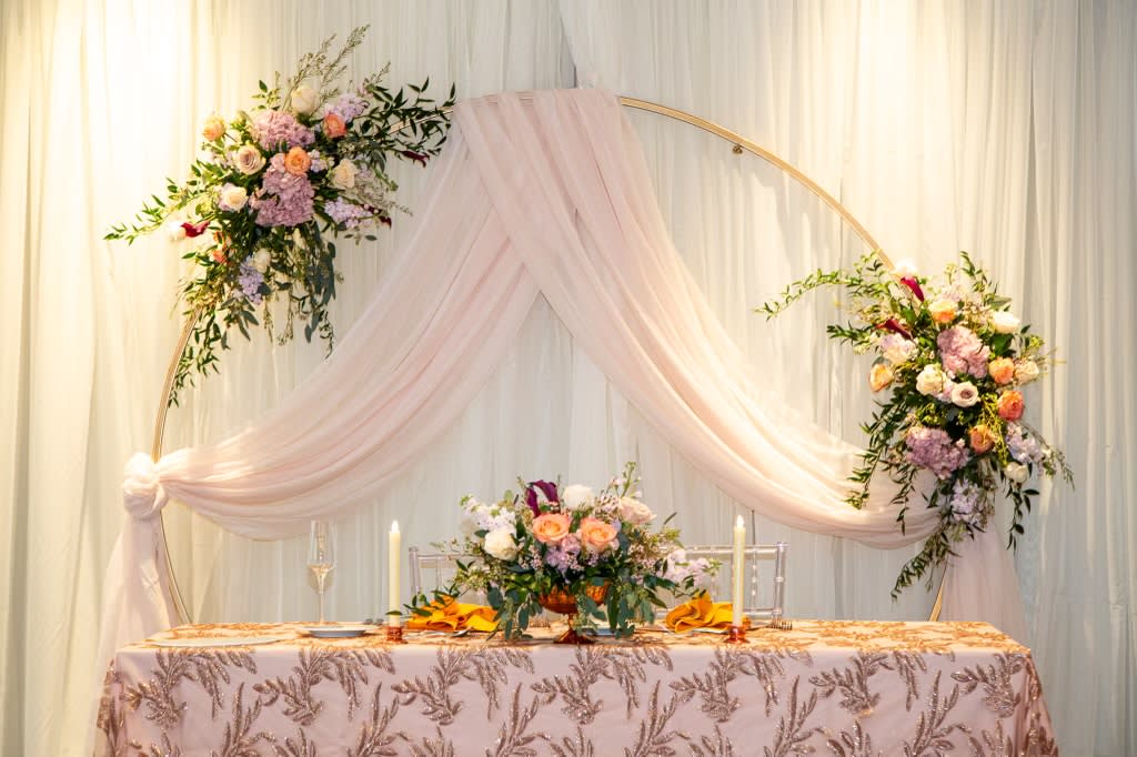 Circle Backdrop - Gold - Create your own backdrop or focal point at your event. This metal circle arch is a beautiful addition to your event covered in florals, greenery or balloons. Lightweight metal is easily weighted with sand bags (not included). 6ft Tall 6ft Wide Ordering online is not available. Call or email to inquire availability and additional fees.