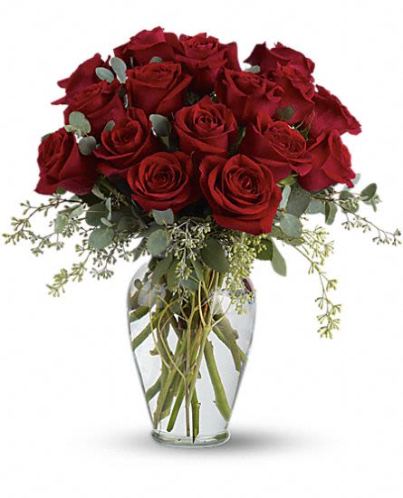 Full Heart - What suggests a full heart more than rich, red roses?  Red roses are presented with fragrant eucalyptus in a lovely glass vase. 