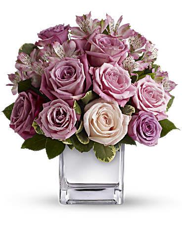 Rose Rendezvous Bouquet - This tastefully terrific bouquet features soft pink and lavender roses in a sleek contemporary silver cube vase. Understated and spectacular at the same time, it is a gorgeous gift that she''ll long remember.