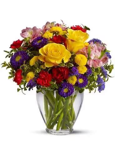 Brighten Your Day - With an abundant array of bright red, yellow and purple flowers, this arrangement is sure to brighten your day. Roses, alstroemeria, asters, carnations and chrysanthemums are delivered in a cheerful clear glass vase.