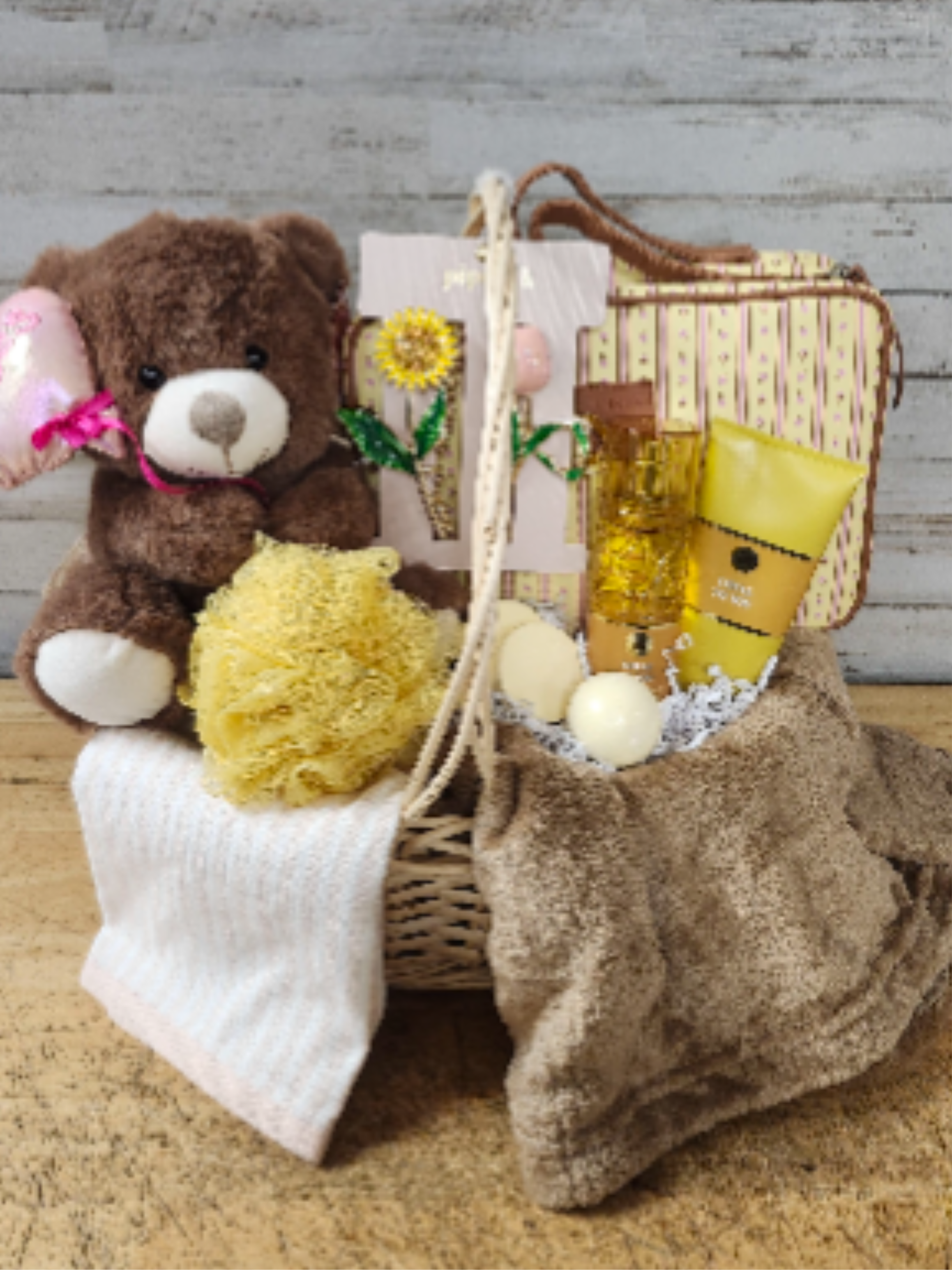 Love &amp; Loyalty - $170 - Show your affection with this cheerful gift basket, containing:  - Plush Throw Blanket - Cute &amp; Stylish Makeup Bag - Set of Metal Hairclips - Tulip &amp; Sunflower - Loyal To You      - Body Lotion      - Fragrance Mist - Decorative Hand Towel - Loofa - Bath Bomb - Shower Fizz - Plush Bear - Wicker Basket with Handle