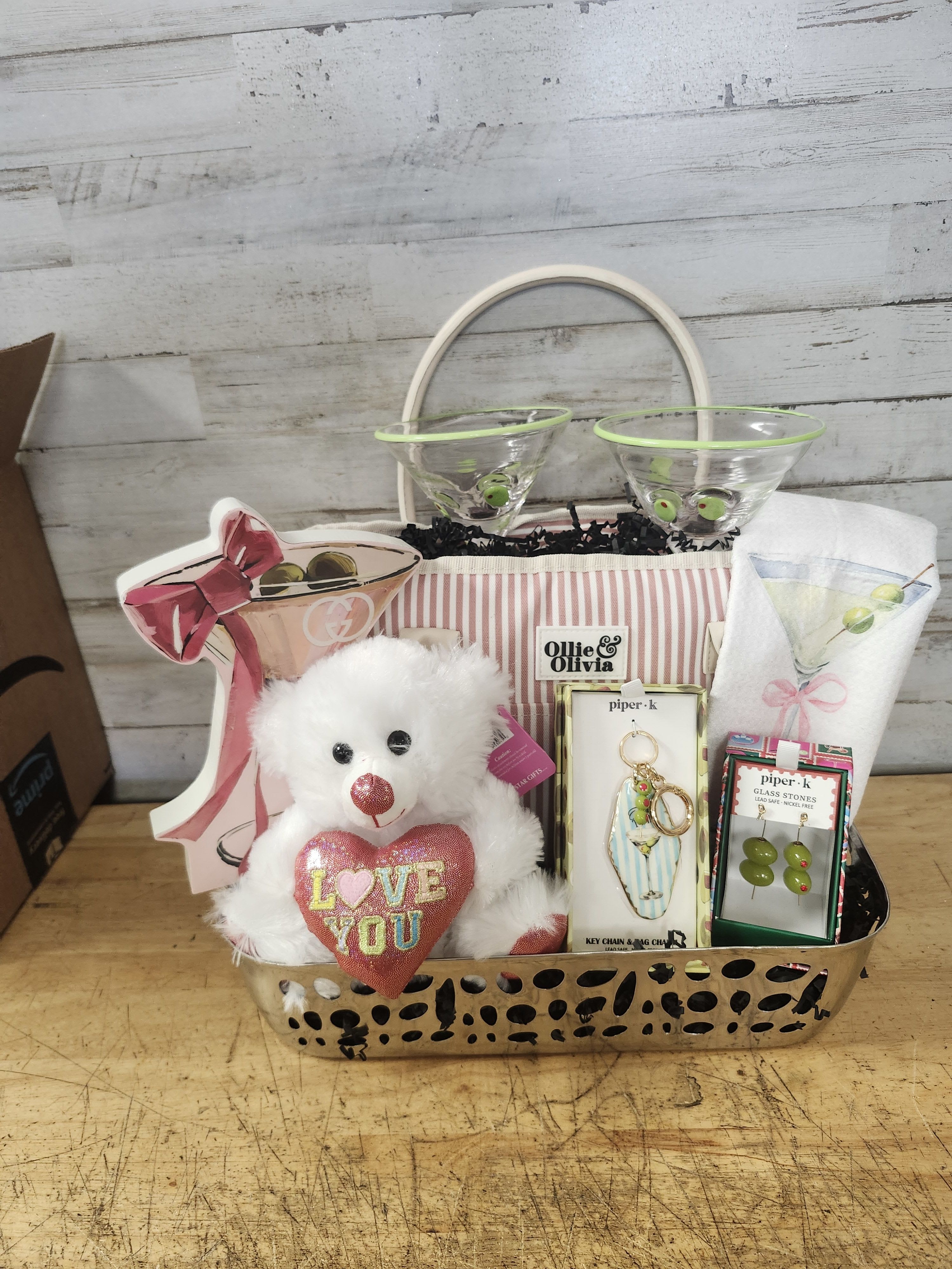 Martini Love - $155 - Make Anytime Martini Time!   Basket Contains: - Designer Style Martini Decor - Martini &amp; Bows Tea Towel  - Set of Two Martini Glasses with Olive Embellishments - Pink Striped Cooler/Lunch Bag - Martini &amp; Olive Keychain/Bag Charm - Olive on Skewer Earrings - Metal Cocktail Tray - Cute Plush Teddy