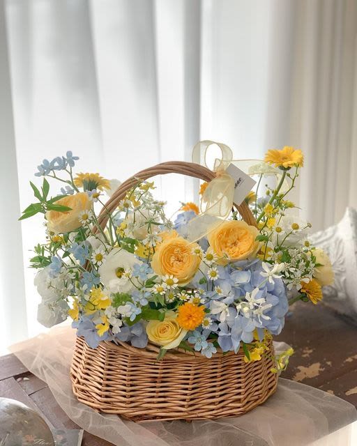 Spring Happiness Bouquet - Beautiful spring bouquet in a basket with a spring mix of blues and yellows.