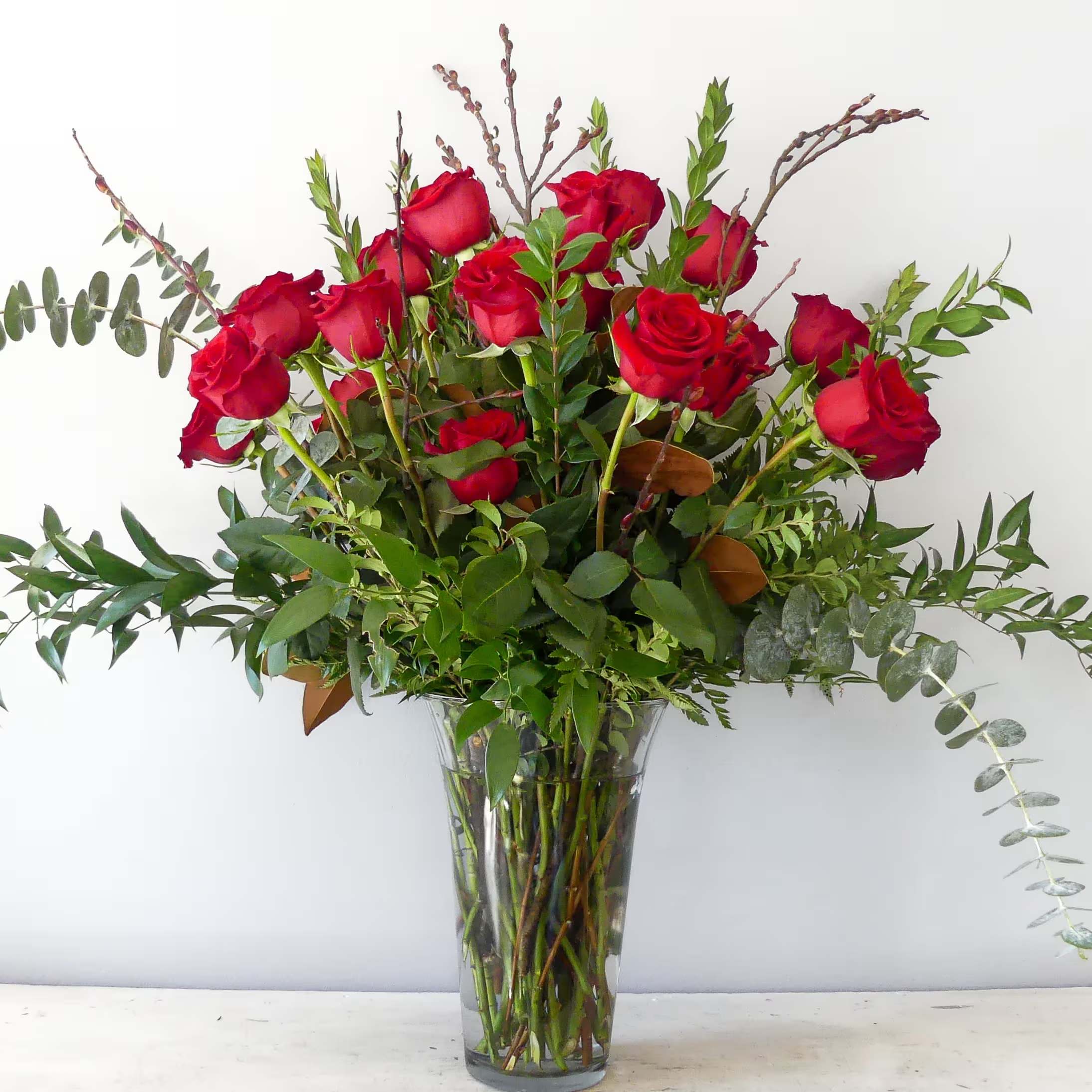 Always and Forever - 2 dozen beautiful red roses arranged in a vase with lush greenery.