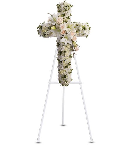 Divine Light Cross - Your message of hope for eternal serenity is delivered ever so elegantly in this graceful cross. Your sincerity will be acknowledged by all who are present. Crème roses, white spray roses, oriental lilies, stock, leptosporum, cushion and button spray chrysanthemums create a cross that is a beautiful way to honor a loved one.Approximately 22 1/2" W x 36" H Orientation: One-Sided As Shown : T232-2A