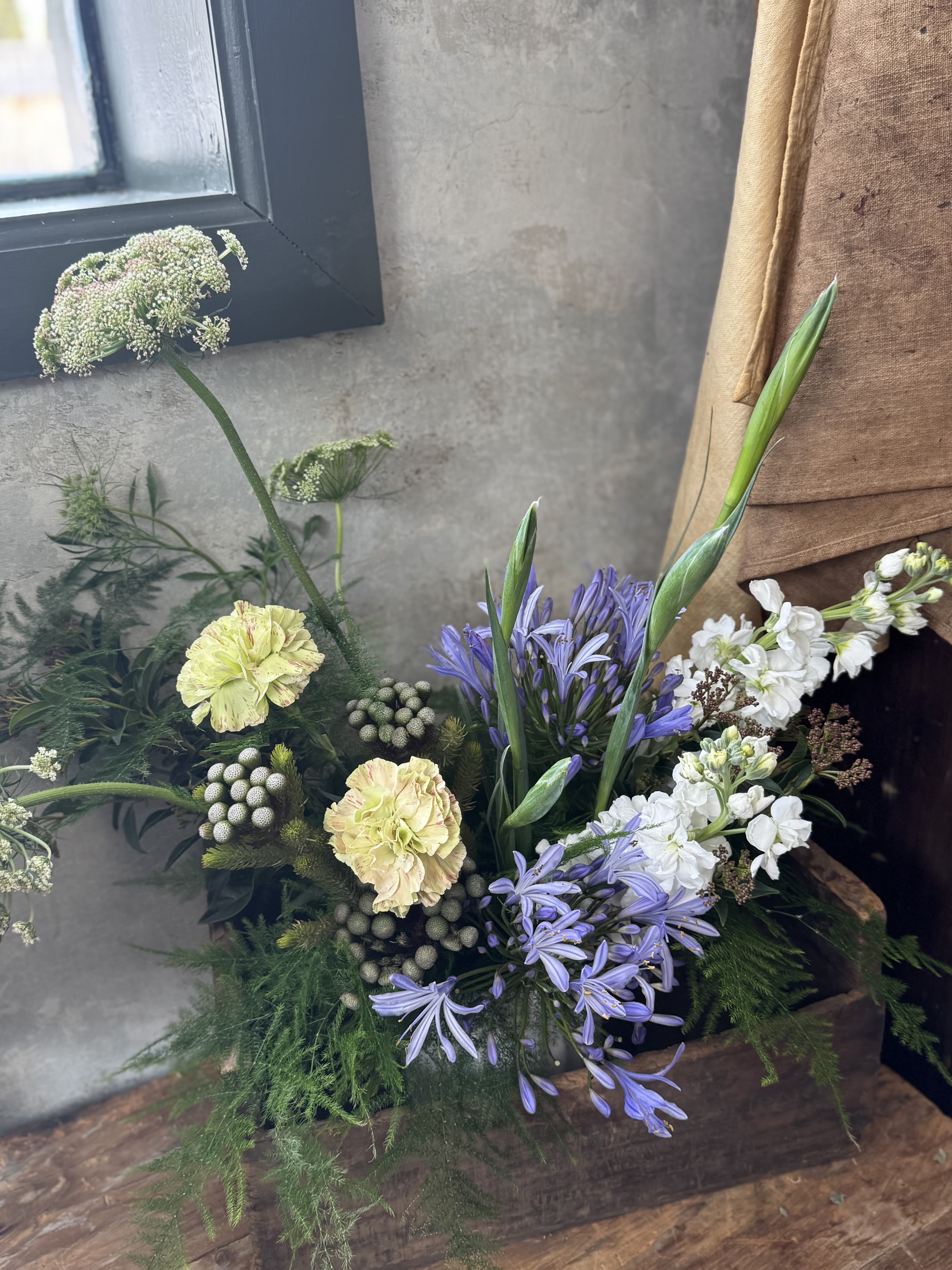 Spring Centerpiece - Bring the beauty of spring to your table with a one of a kind seasonal centerpiece, thoughtfully arranged by us. Each piece is unique and designed in fresh, garden inspired hues. Think soft pastels, creamy whites, delicate blush, fresh greens, and airy pops of color. Perfectly sized and styled for your table, these arrangements capture the lightness and renewal of the season.  Every centerpiece is florist’s choice, ensuring a fresh, artful design made with the best blooms available. If you have a particular color palette in mind, please let us know before checkout; we’re happy to create something that complements your celebration perfectly.