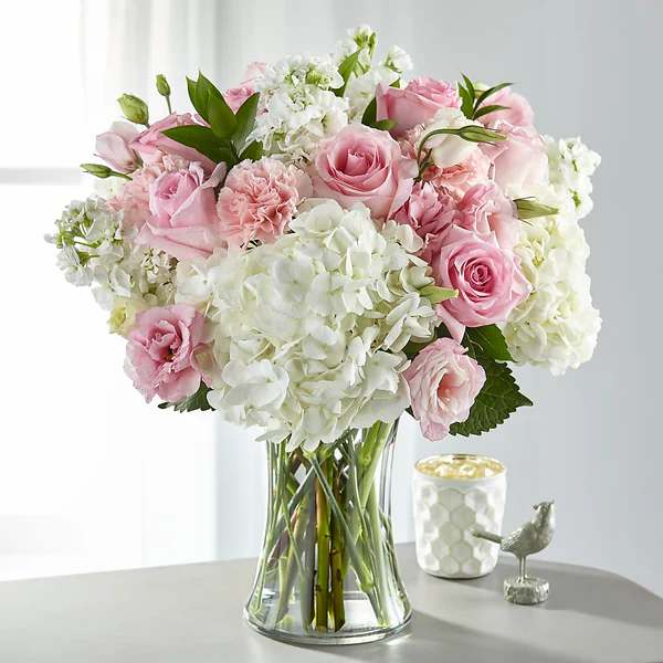 Guiding Grace Bouque - .This beautiful bouquet is a soft and elegant arrangement featuring   blushing pink and pure white blooms. An array of hydrangea, stock, roses and lisianthus come together in a glass vase to create our Guiding Grace Bouquet