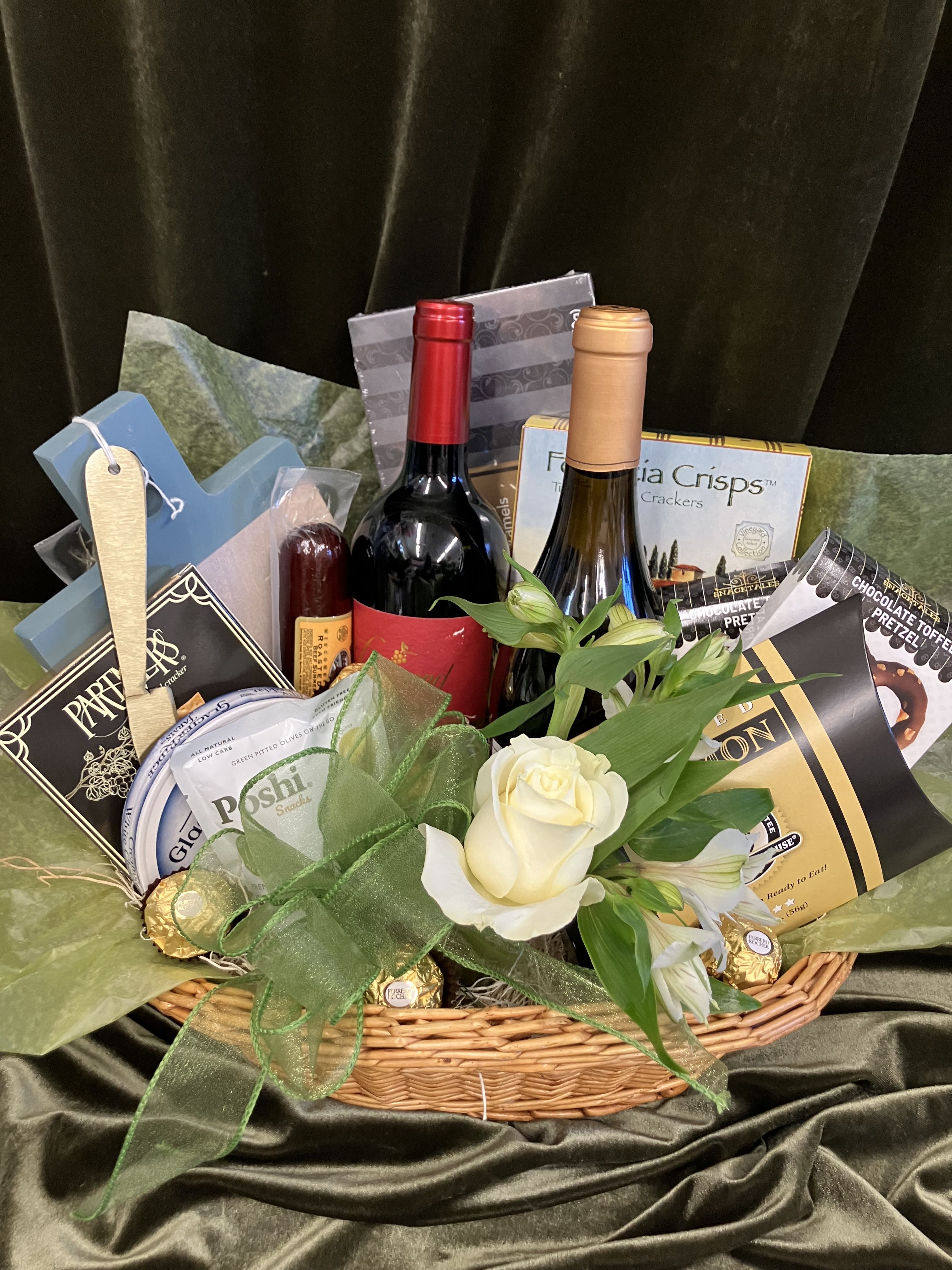 Wine Country Gourmet Basket - Send an outstanding gift basket that includes, two bottles of wine, cheese, two meats, crackers, dark chocolate salted caramels and a sweet flower arrangement of white rose and alstroemerias. Guaranteed to impress, a gift for many occasions