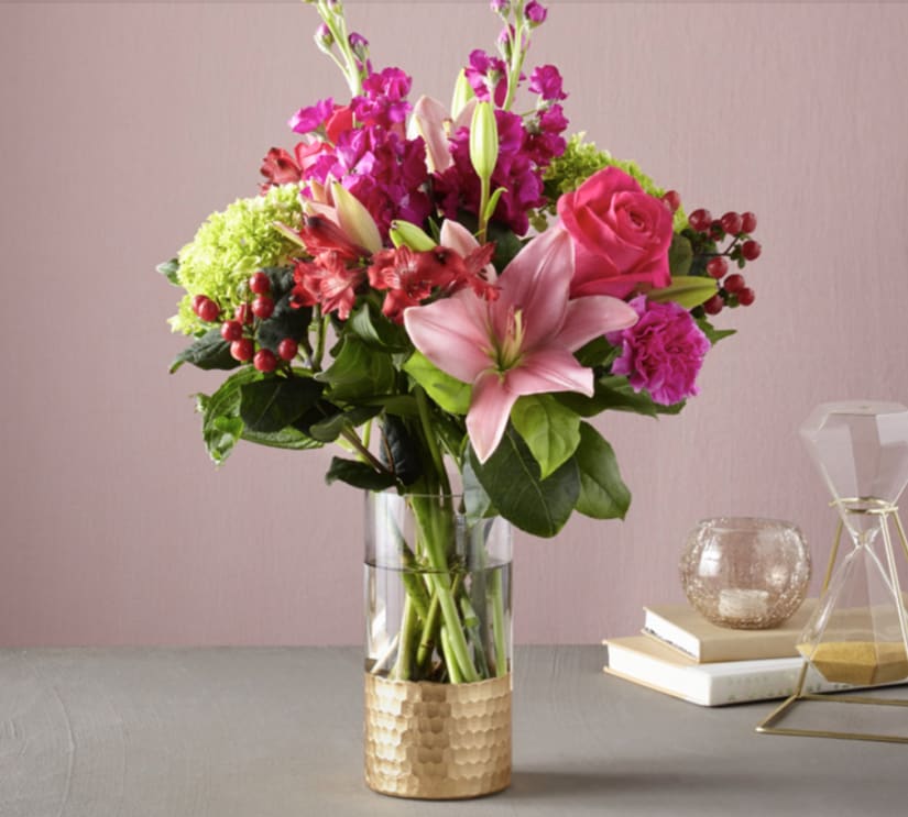 Pink and magenta floral arrangement in a clear glass vase